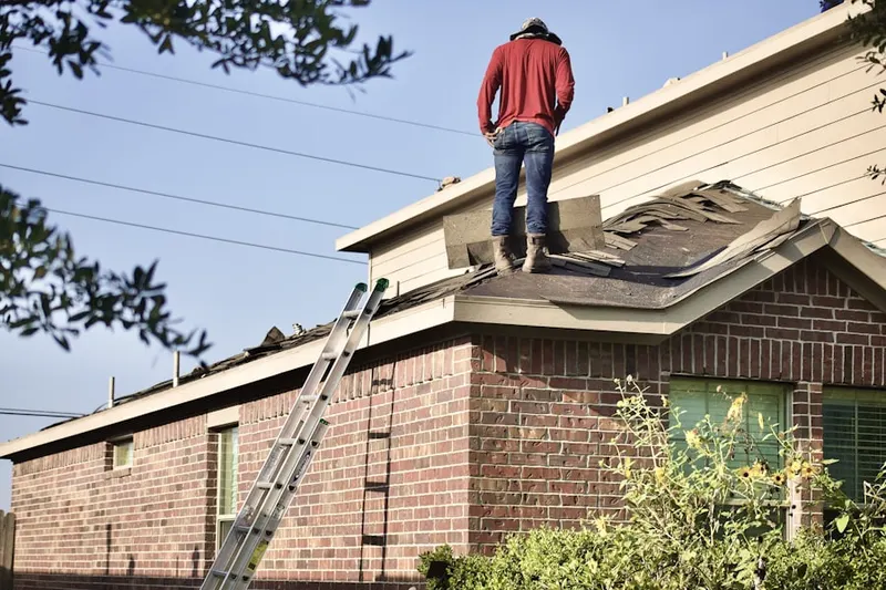 Professional roofer working on a residential roof in Bank Square